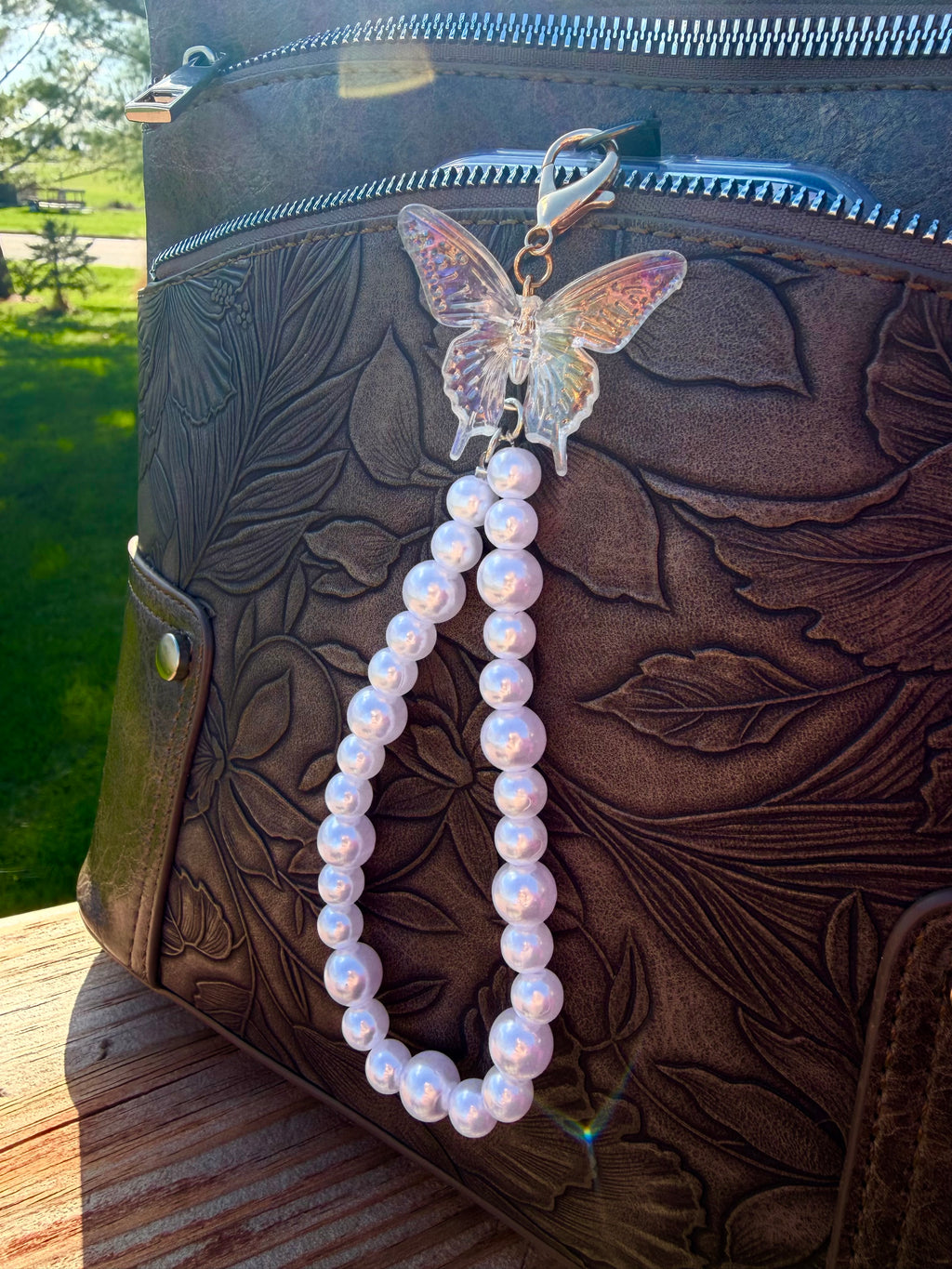 Pearl phone wristlet with ice crystal butterfly accent bead