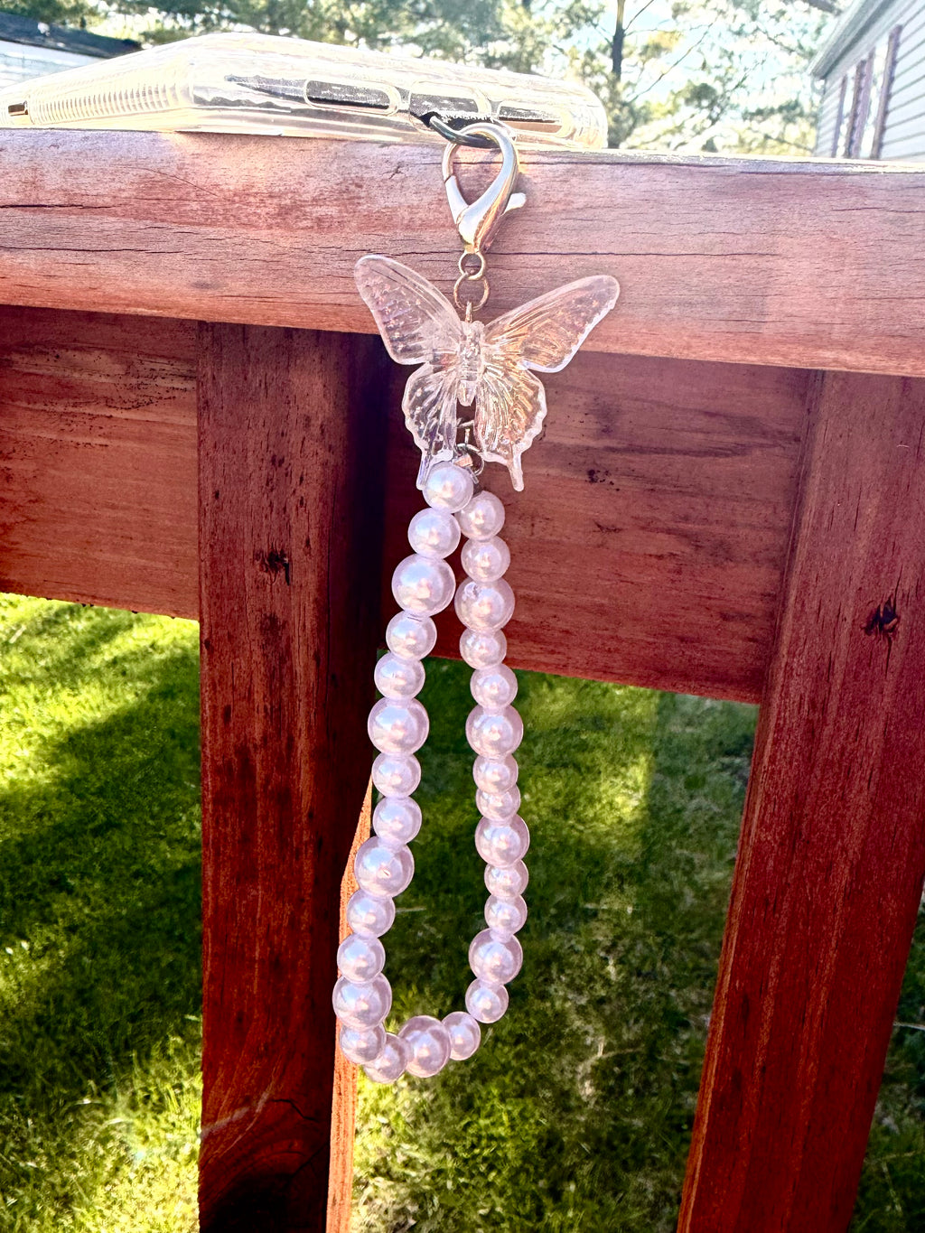 Pearl phone wristlet with ice crystal butterfly accent bead