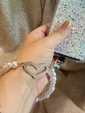 Pearl phone wristlet with rhinestone heart accent