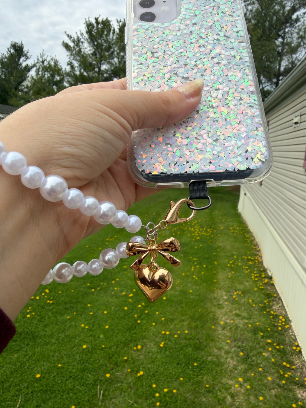 Pearl Phone Wristlet with brass tone heart and bow charm