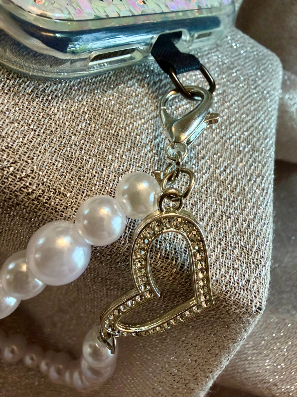 Pearl phone wristlet with rhinestone heart accent
