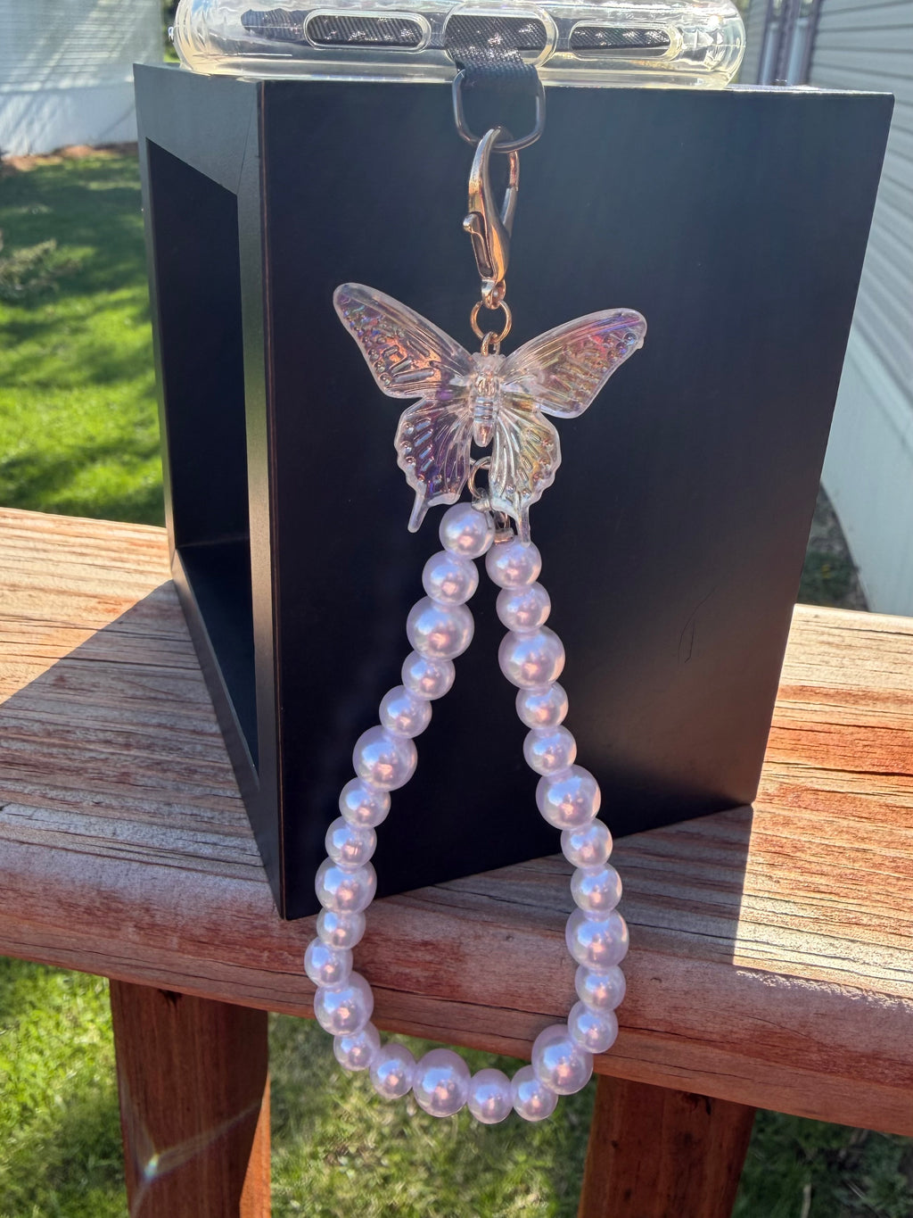 Pearl phone wristlet with ice crystal butterfly accent bead