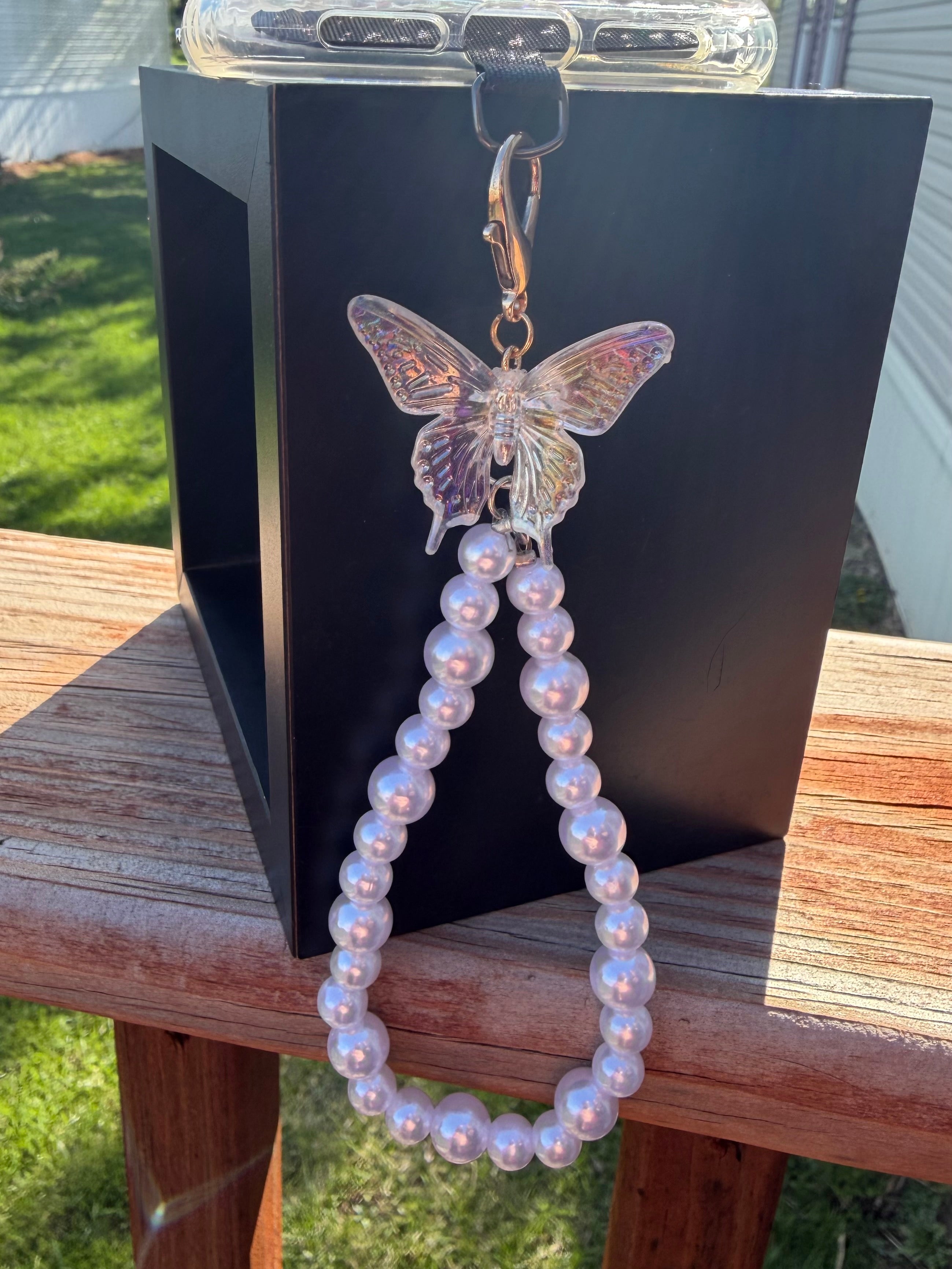 Pearl phone wristlet with ice crystal butterfly accent bead