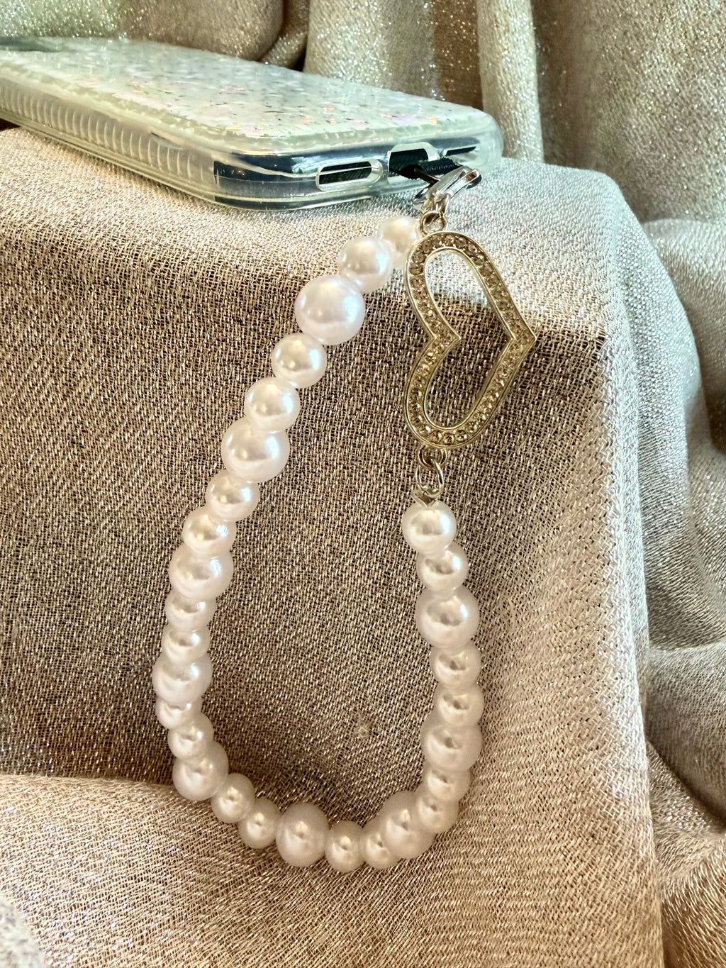 Pearl phone wristlet with rhinestone heart accent