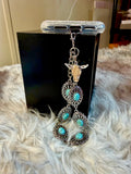 Western turquoise and silver tone phone wristlet with desert skull accent charm