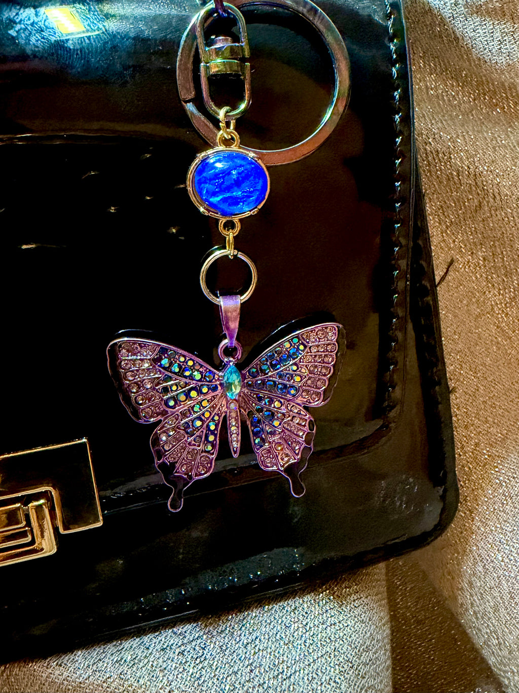 Blue and Purple Rhinestone Butterfly Keychain with iridescent blue accent bead and oil spill Clasp