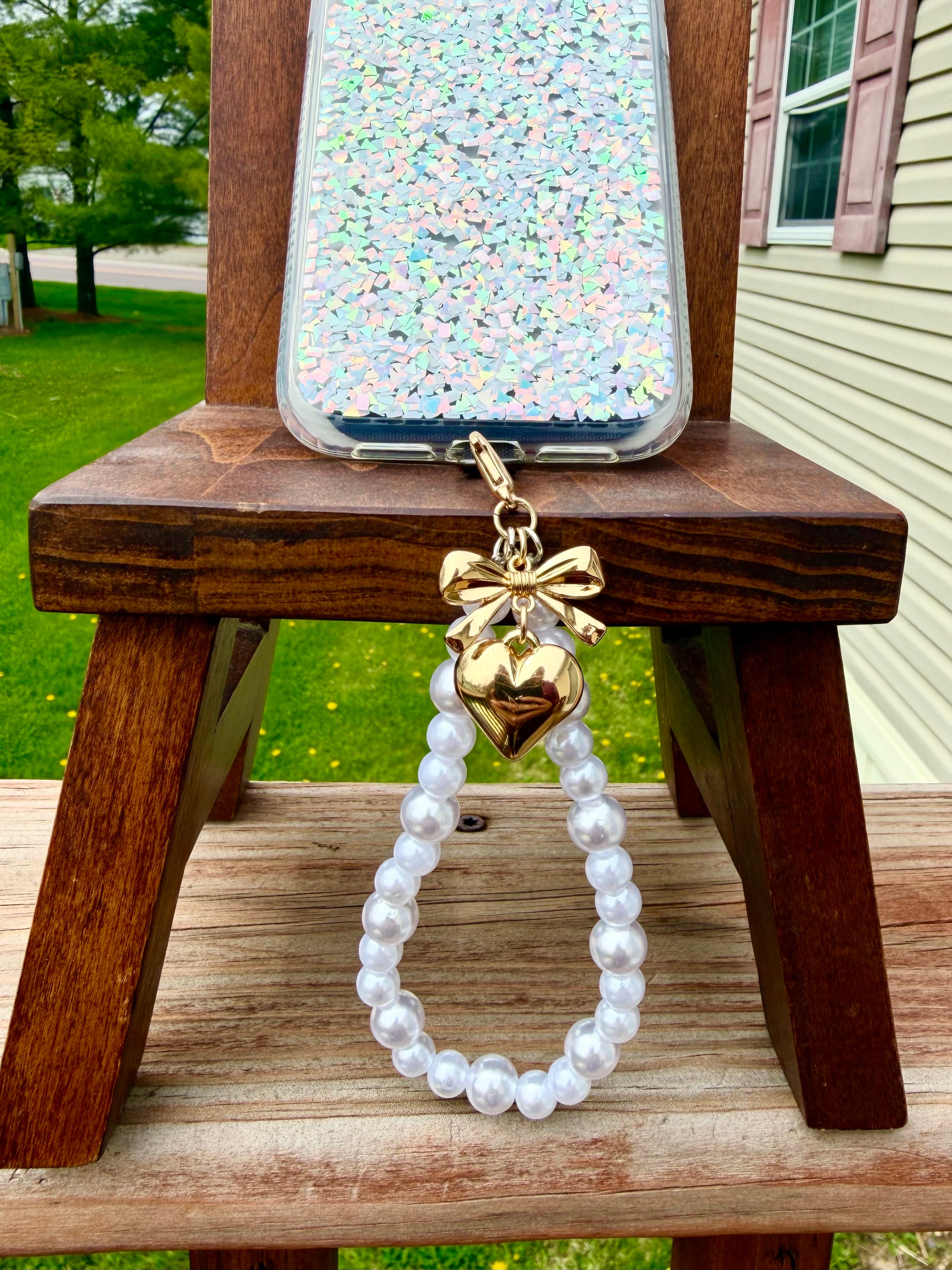 Pearl Phone Wristlet with brass tone heart and bow charm