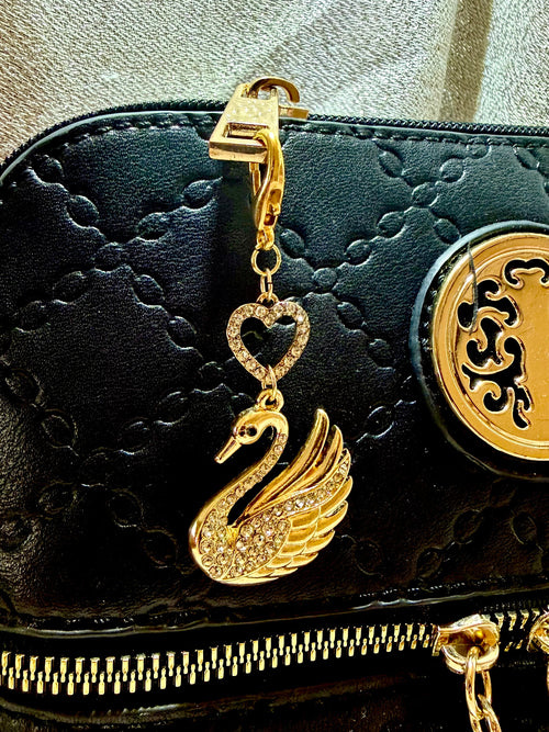 Brass tone rhinestone swan with heart bead accent bag charm