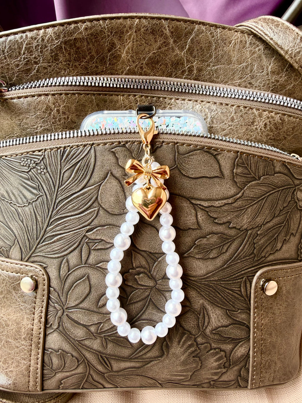 Pearl Phone Wristlet with brass tone heart and bow charm