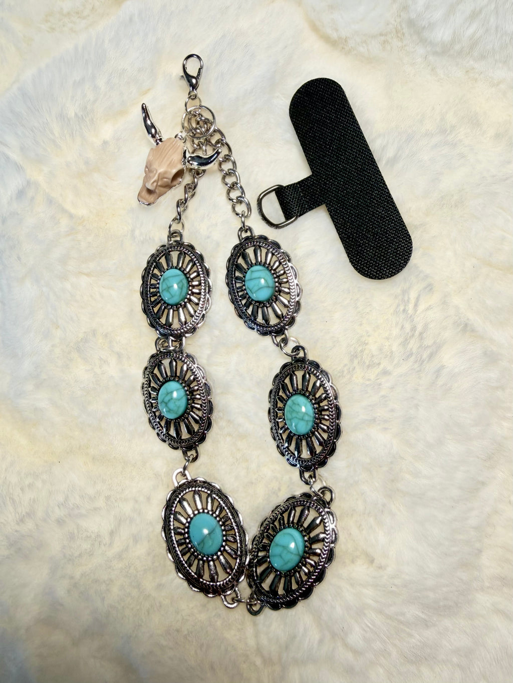 Western turquoise and silver tone phone wristlet with desert skull accent charm