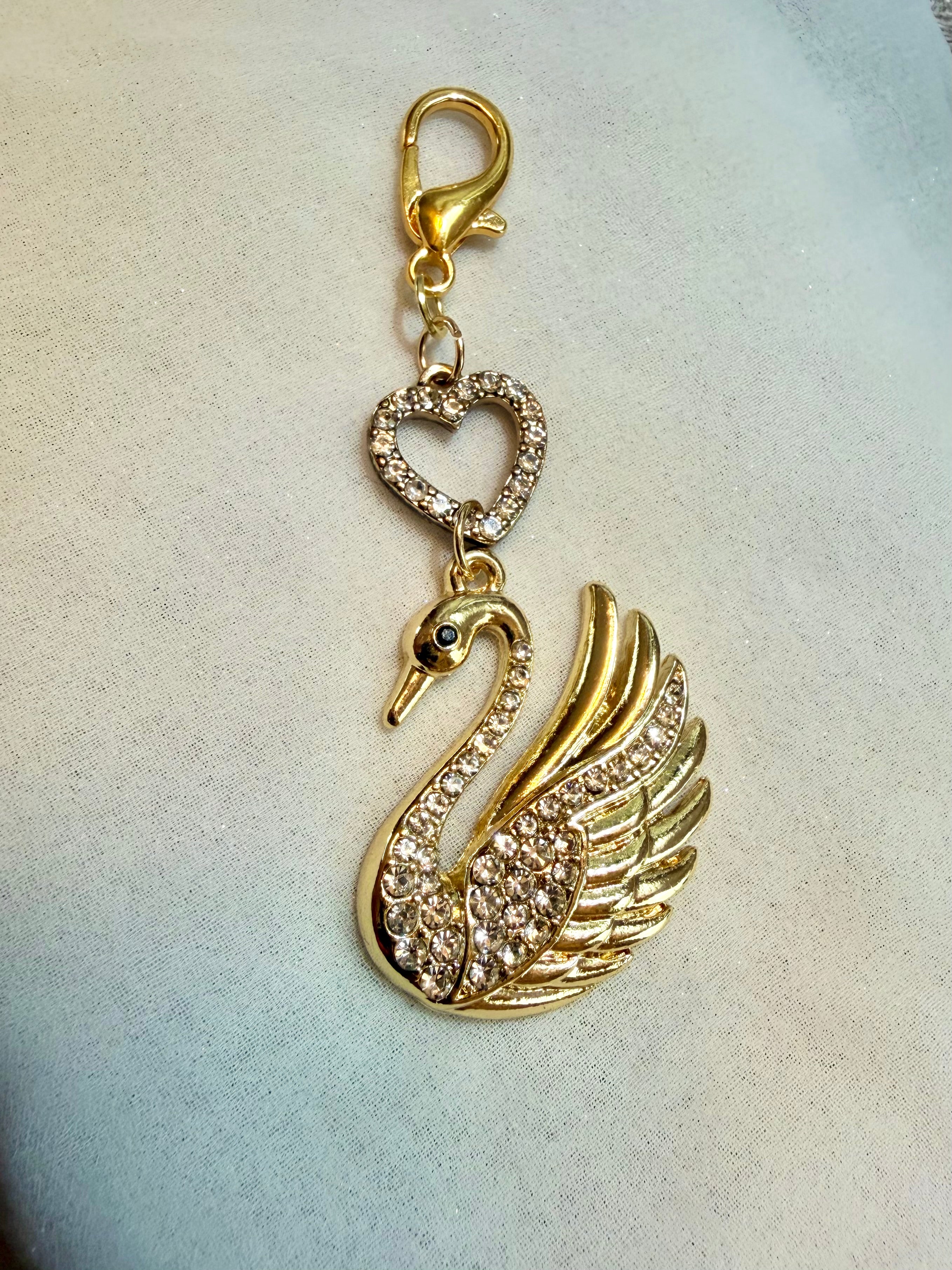 Brass tone rhinestone swan with heart bead accent bag charm